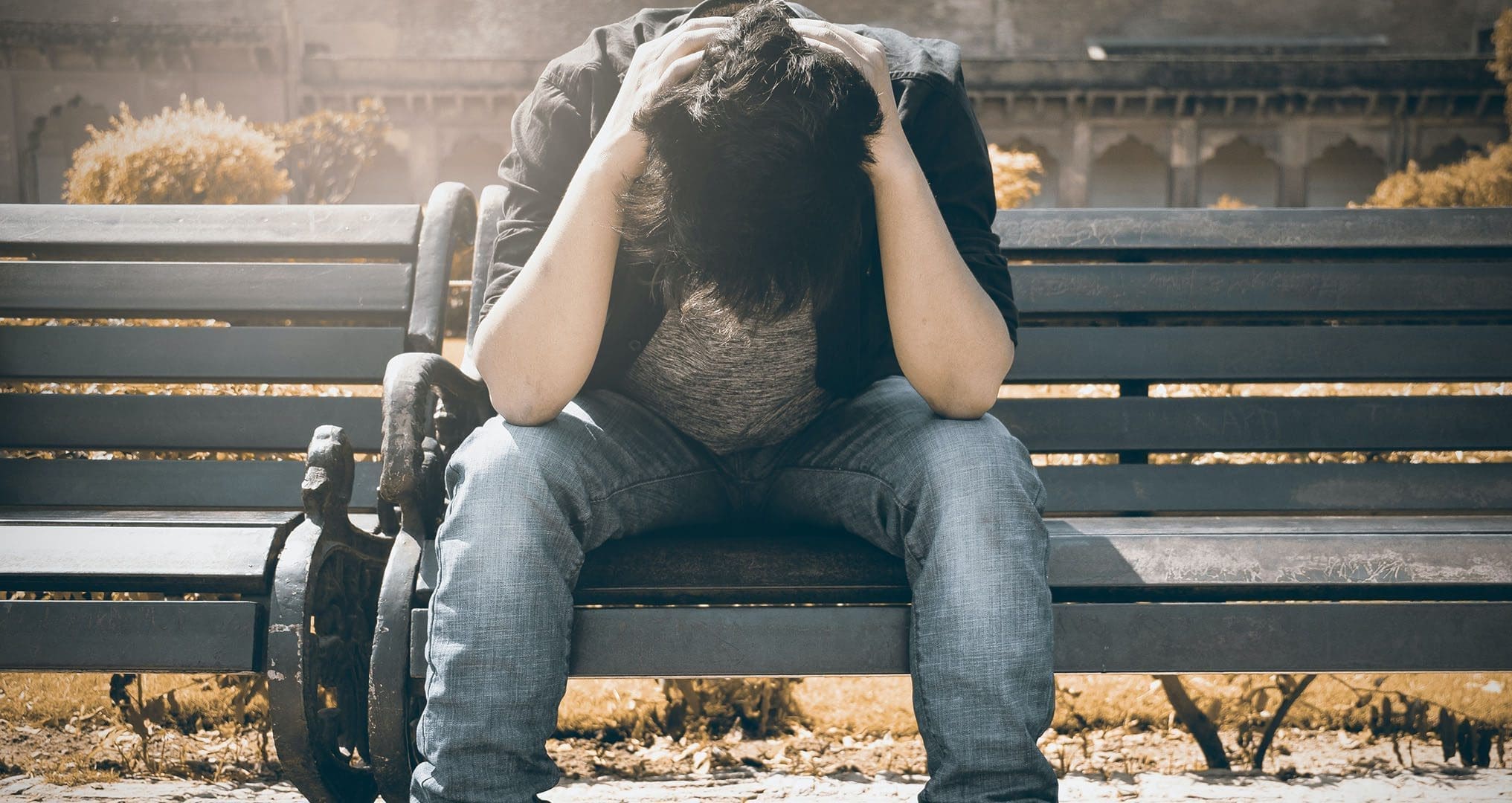 Man sitting on bench suffering depression