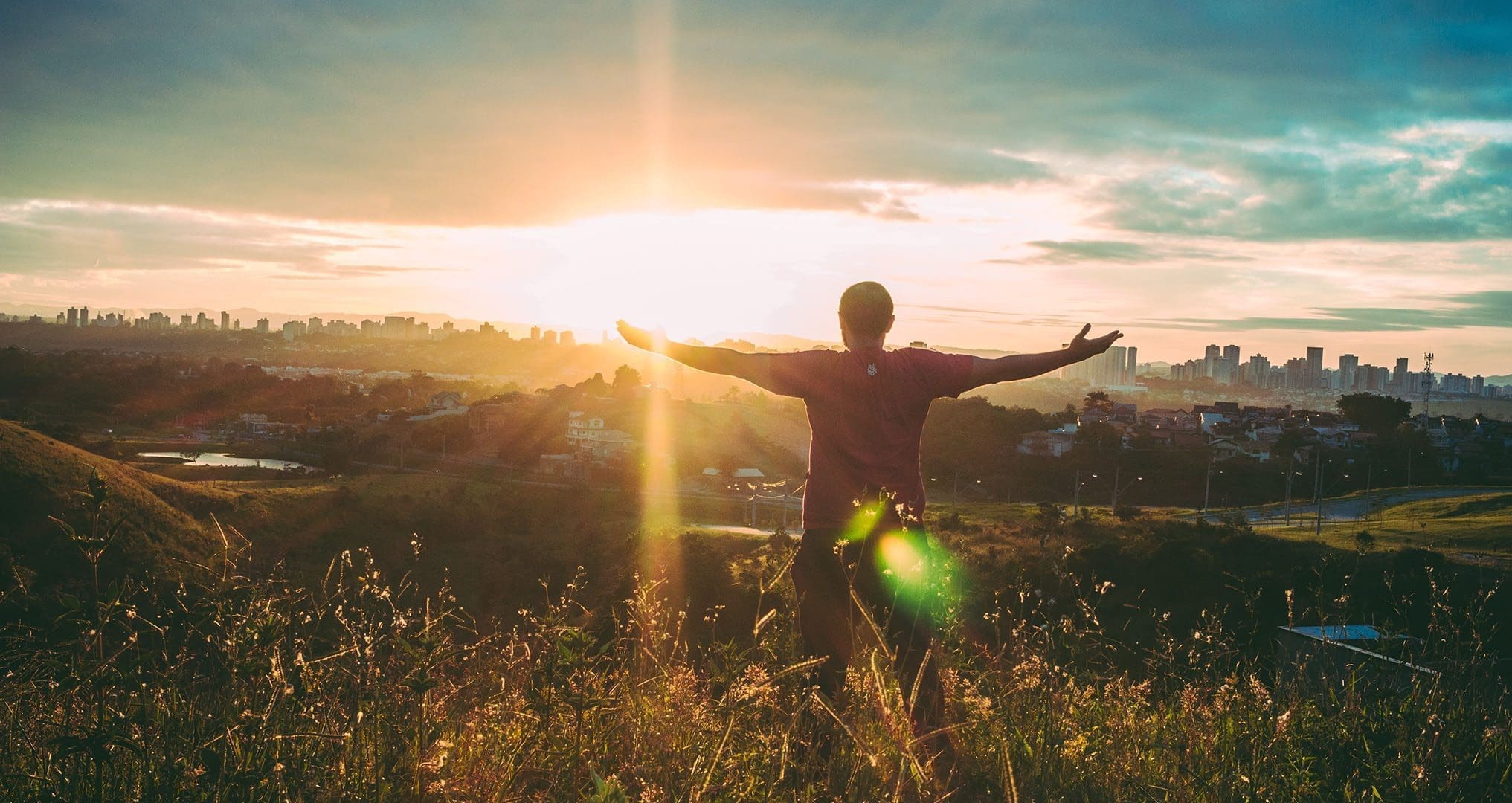 person standing in field during sunset happy to have Grey Matters of Carmel