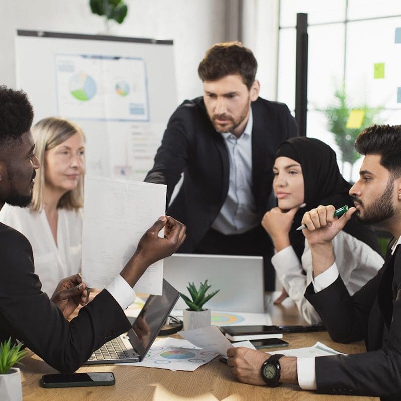 employees focused on team meeting employees focused on team meeting
