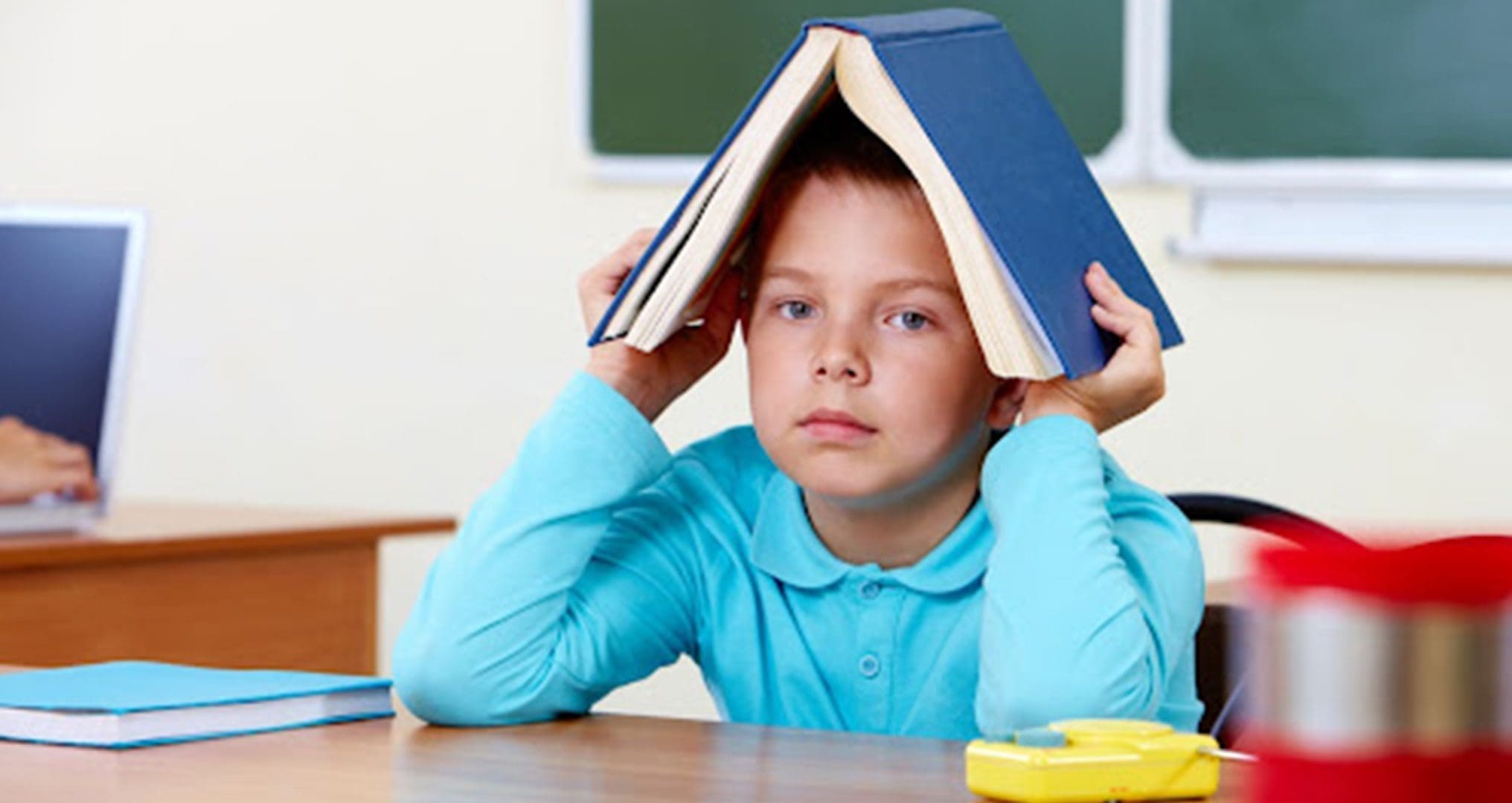 child with book overhead