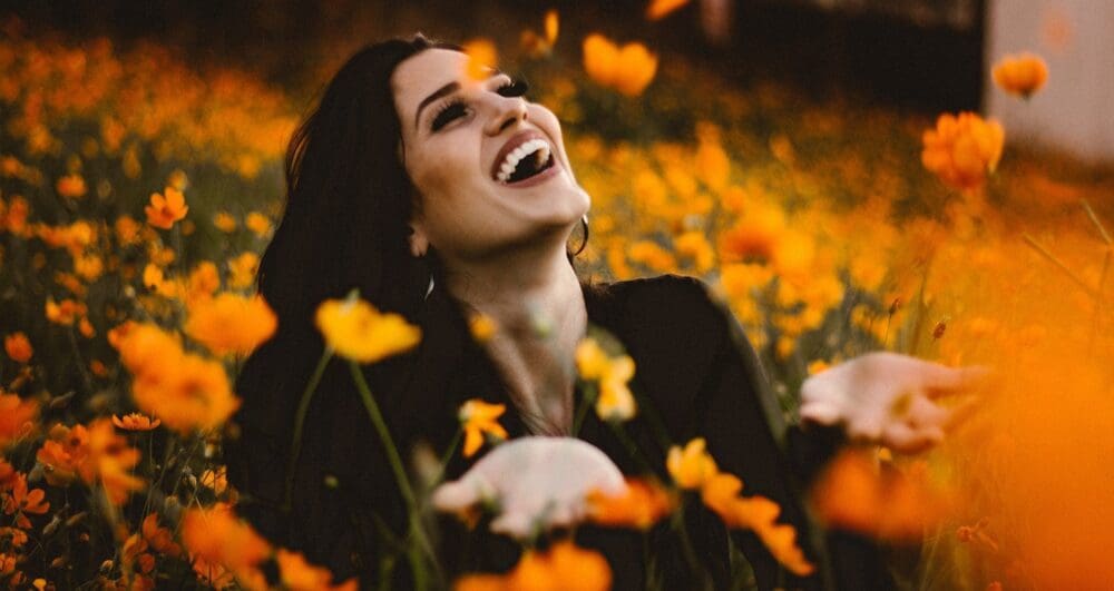 woman in fall flower field woman in fall flower field