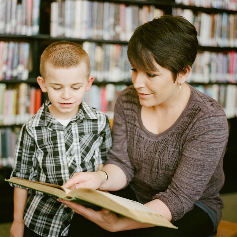 mom reading book to son