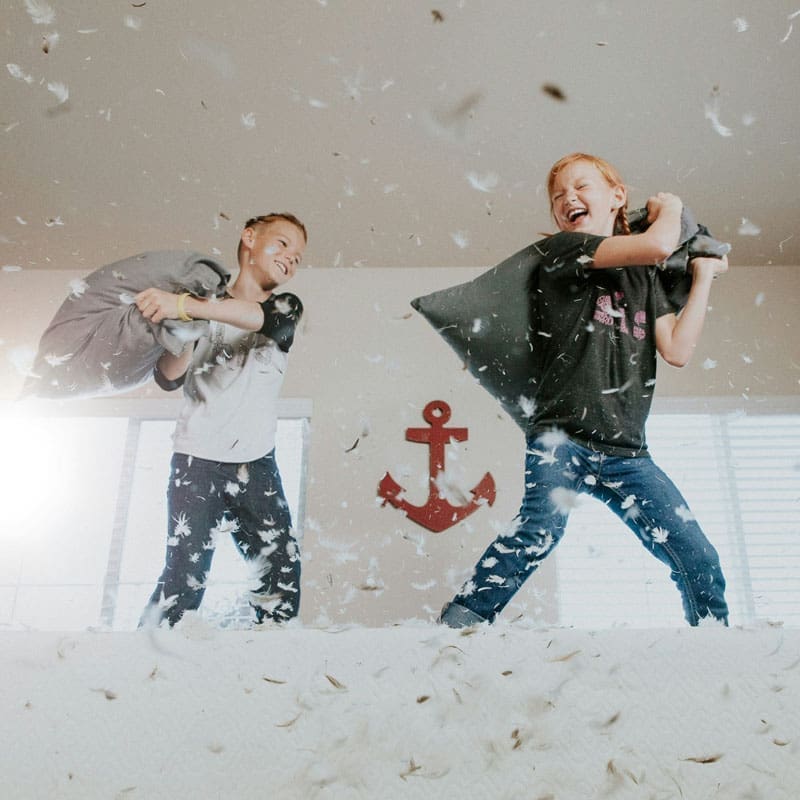 kids having a pillow fight kids having a pillow fight