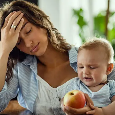 mom holding child, experiencing postpartum depression