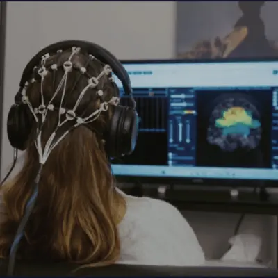 girl wearing brain map cap during neurofeedback session